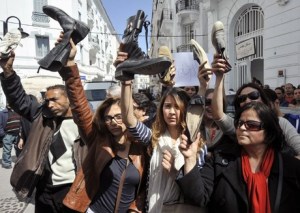 Protesters brandishing shoes during a demonstration to demand the resignation of Tunisian Minister of Women's Affairs, Sihem Badi on March 29, 2013 in Tunis. Badi is highly criticized for months for her good relations with the Islamist ruling party Ennahda and recently for her support to a kindergarten where a three-year-old girl has been raped. AFP PHOTO / FETHI BELAID